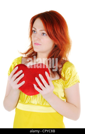Young beautiul woman with red heart in her hands on white background. Focus on woman's eyes. Stock Photo