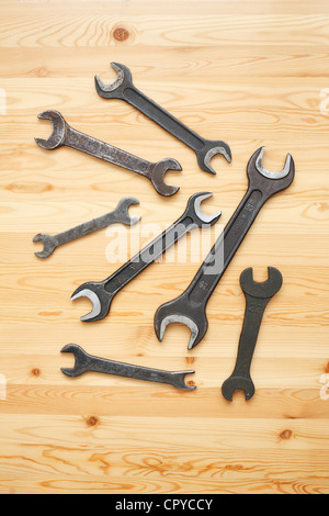 Several spanners lie on light wood Stock Photo