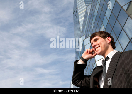 Handsome young man calling against office Stock Photo