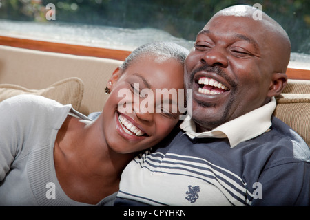 Couple sitting on couch, Illovo Family, Johannesburg, South Africa. Stock Photo