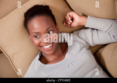 Woman relaxing on couch,  Illovo Family, Johannesburg, South Africa. Stock Photo