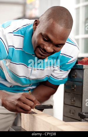 African man making measurements in a workshop Stock Photo