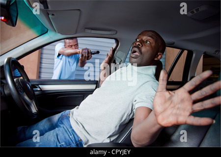 Inside view of a man getting hijacked in his car Stock Photo
