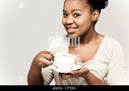 Young black woman drinking tea, smiling Stock Photo