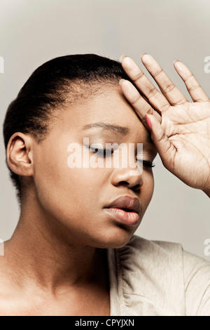 Portrait of young black woman, looking feint Stock Photo