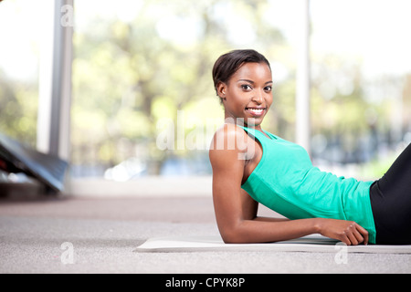 Young black female posing in a gym, smiling at camera Stock Photo
