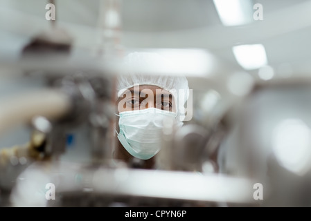 Lab technician working as researcher in biotechnology plant with machinery Stock Photo