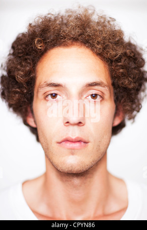 Young man with curly hair, portrait Stock Photo