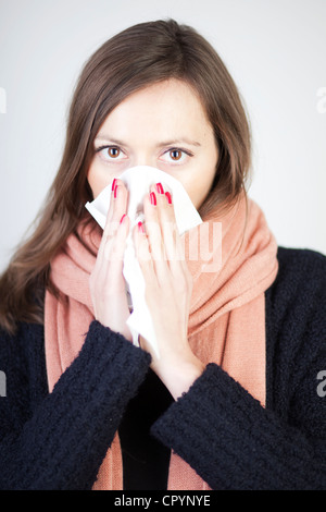 Woman blowing her nose with a handkerchief Stock Photo