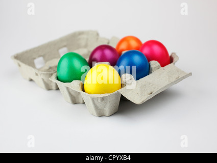 Colourful Easter eggs in an egg box Stock Photo
