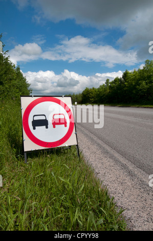 no overtaking warning sign due to loose chippings on newly resurfaced road uk Stock Photo