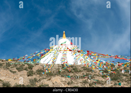 Tibetan Buddhism, white stupa with colorful prayer flags against a blue sky, Hepo Ri above Samye Monastery, Himalaya Range Stock Photo