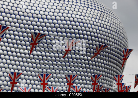 Part of the iconic Selfridge's building in Birmingham with Union Jack pennants strung high in the air in front of it. Stock Photo