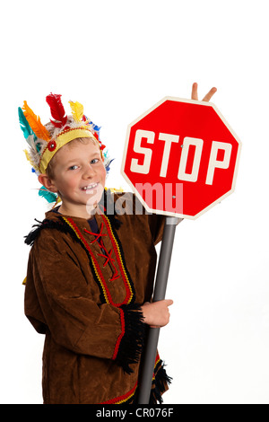 A boy, 7 years, wearing American Indian fancy dress, with stop sign Stock Photo