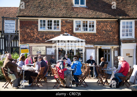 People seated outside Tea Room. High Street. Battle. East Sussex. England. Stock Photo