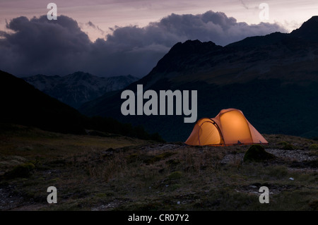 Camp tent lit up at night Stock Photo