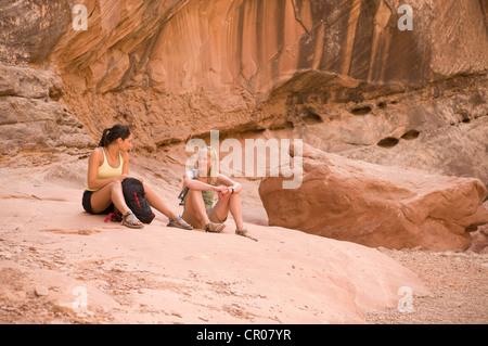 Rock climbers relaxing on boulder Stock Photo