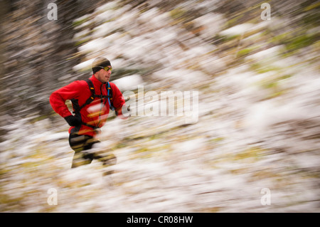 Blurred view of man running in snow Stock Photo