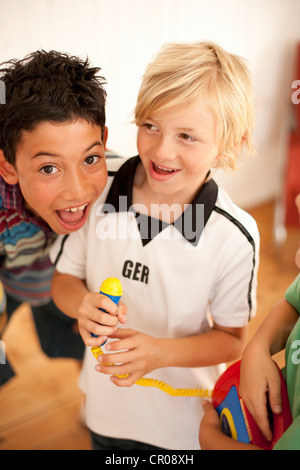 Boys playing together indoors Stock Photo