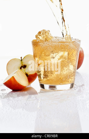 Apple juice being poured into a glass Stock Photo