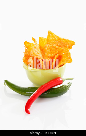 Tortilla chips with hot peppers in a plastic bowl Stock Photo