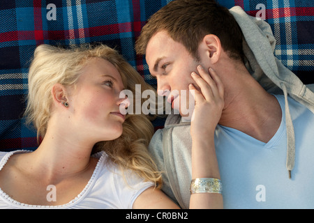 Young couple lying on a picnic blanket Stock Photo