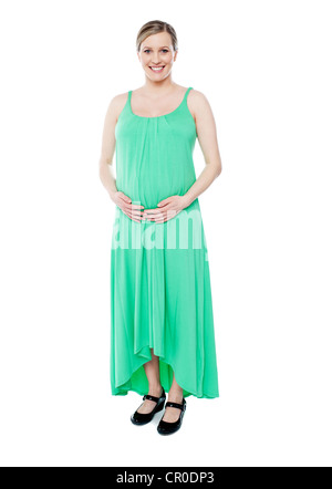Gorgeous brunette pregnant woman dressed like princess in green fashionable outfit Stock Photo