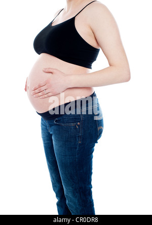 Cropped image of young pregnant woman wearing jeans Stock Photo