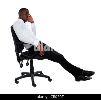Portrait of thoughtful young businessman sitting on chair Stock Photo