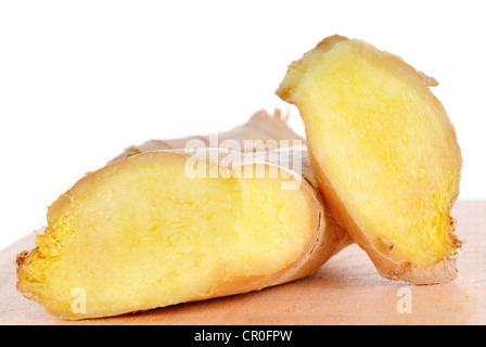 Two cutted ginger roots on wooden board Stock Photo