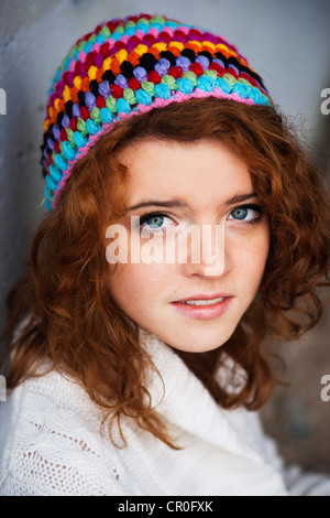 Girl wearing a colourful woollen cap, portrait Stock Photo