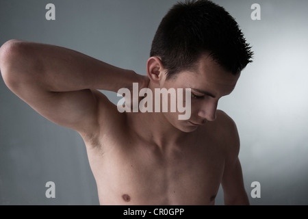 Young man with back pain, neck pain Stock Photo
