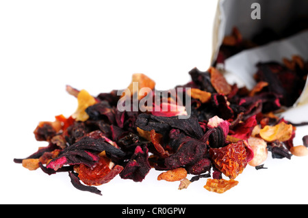 Heap of fruit and floral tea falling out a bag Stock Photo