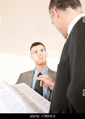 Boss controlling the contract of an employee Stock Photo