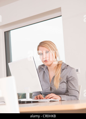 Young woman working on computer Stock Photo