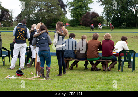 Students watching polo game Stock Photo