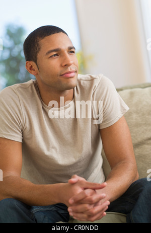 USA, New Jersey, Jersey City, Portrait of man sitting on sofa Stock Photo