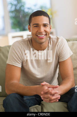 USA, New Jersey, Jersey City, Portrait of man sitting on sofa Stock Photo