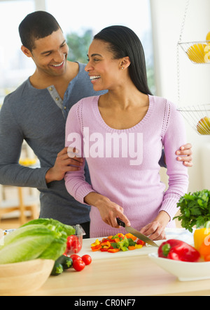 USA, New Jersey, Jersey City, Couple chopping vegetables in kitchen Stock Photo