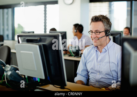 Business people working on computers in call center Stock Photo