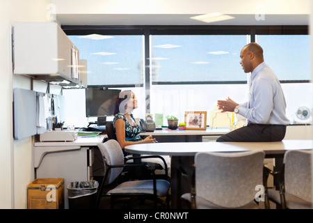 African American co-workers talking in office Stock Photo