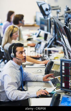 USA, New York, New York City, Traders at trading desk Stock Photo