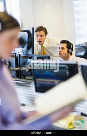 USA, New York, New York City, Traders at trading desk Stock Photo