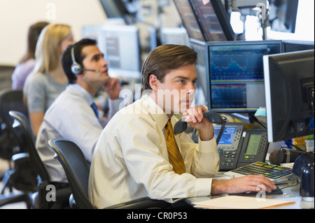 USA, New York, New York City, Traders at trading desk Stock Photo