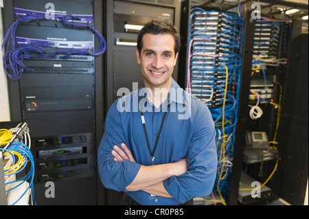 USA, New York, New York City, Portrait of technician in network server room Stock Photo
