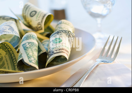 Paper currency on dinner plate, studio shot