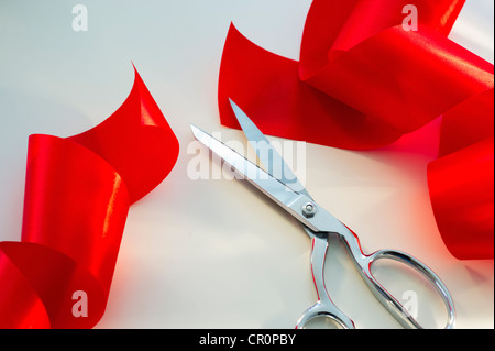 Scissors and red ribbon, studio shot Stock Photo