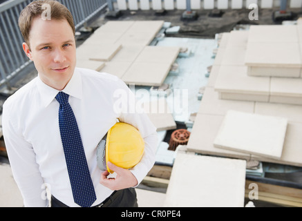 Caucasian businessman standing at construction site Stock Photo