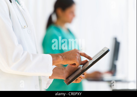 USA, New Jersey, Jersey City, Doctors working on digital tablet and computer Stock Photo