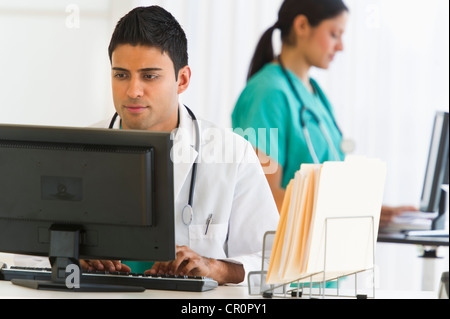 USA, New Jersey, Jersey City, Doctors working on computers Stock Photo